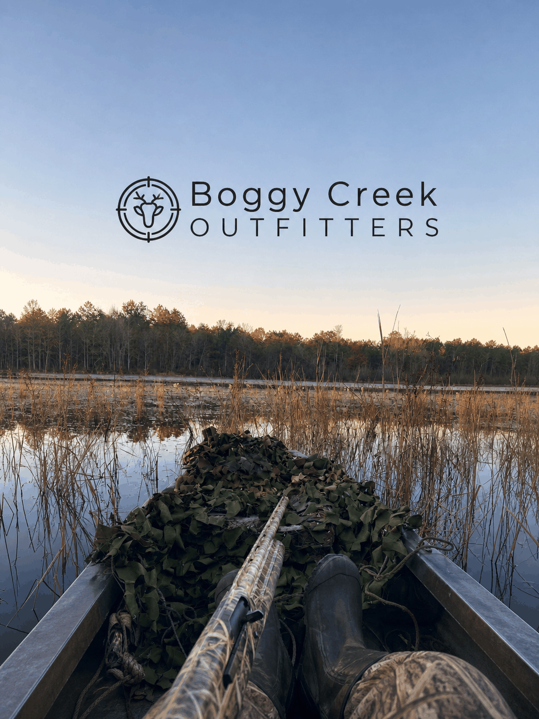 Hunter overlooking a marsh at sunset at Boggy Creek Outfitters